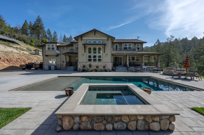 large house with serene river-stone style pool